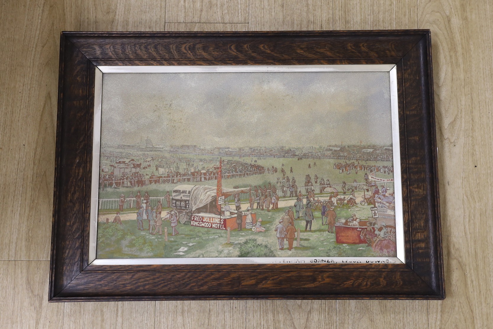 An early 20th century needlework panel depicting Tattenham Corner, Epsom Downs Racecourse, 38 x 60cm, in original glazed oak frame